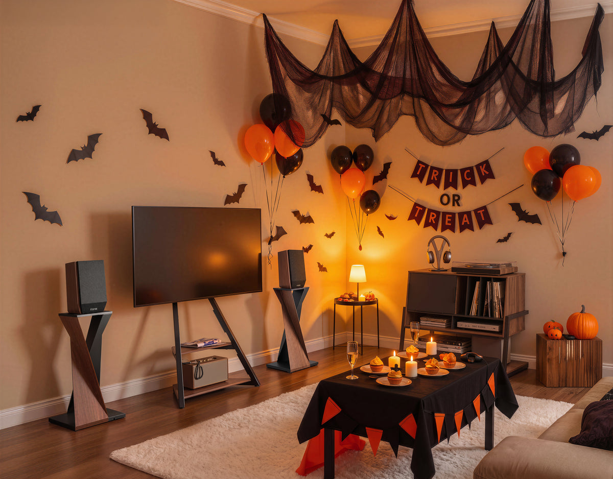 An Eiffel TV stand, two speaker stands and a record player stand styled for an indoor Halloween gathering
